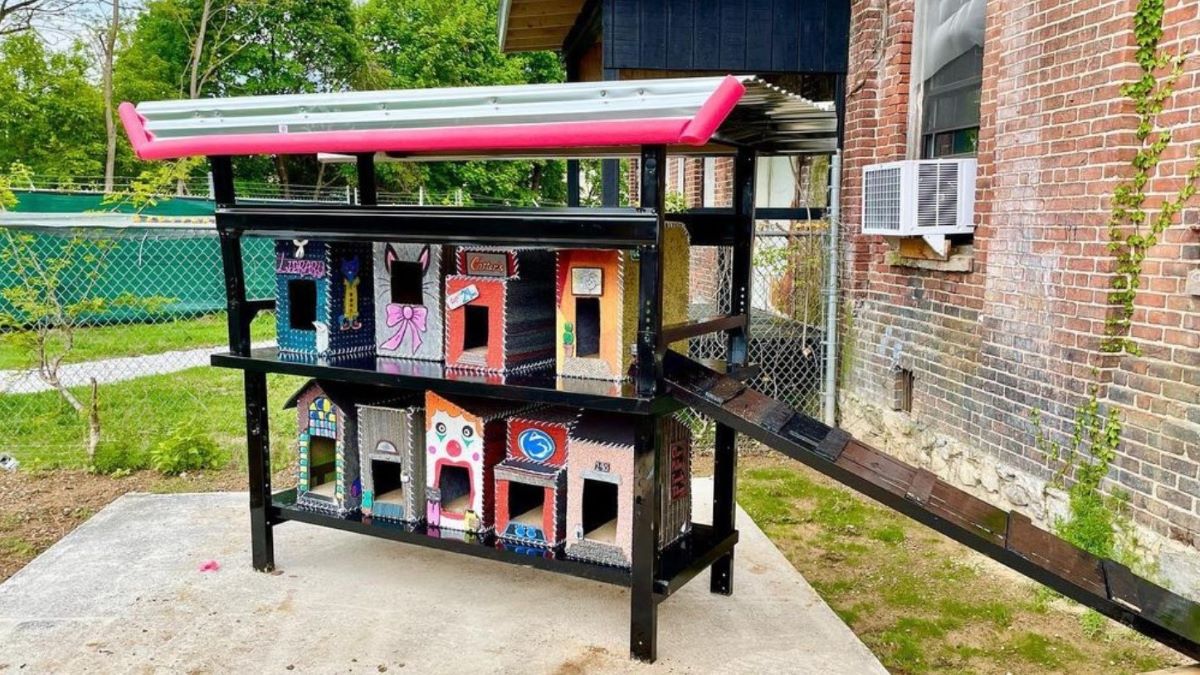 A colorful row of unique cat houses.